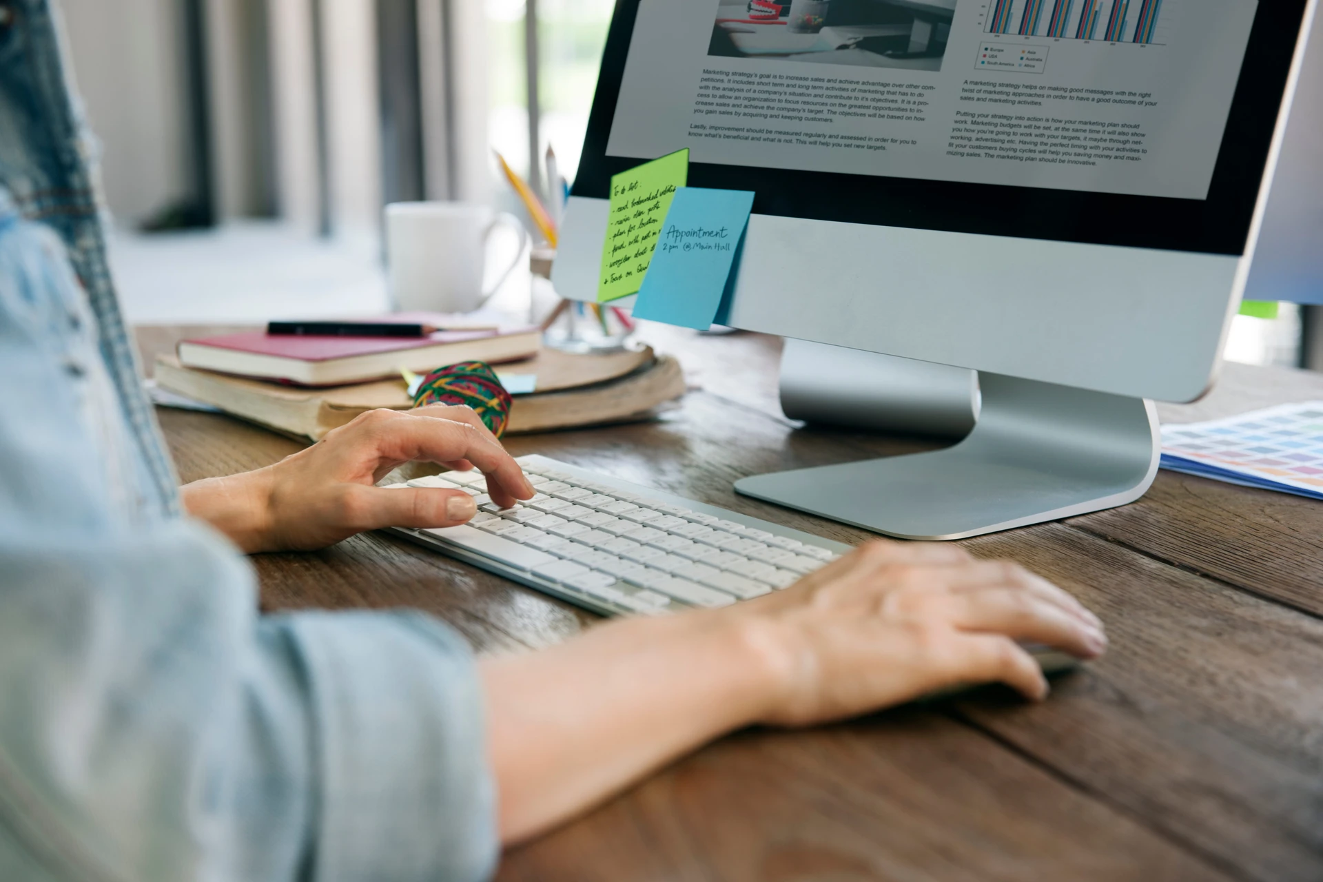 Business Plan Graph Growth Data Analysis Concept A person seated at a desk with dual monitors displaying text and coding, surrounded by tech equipment and a plant.